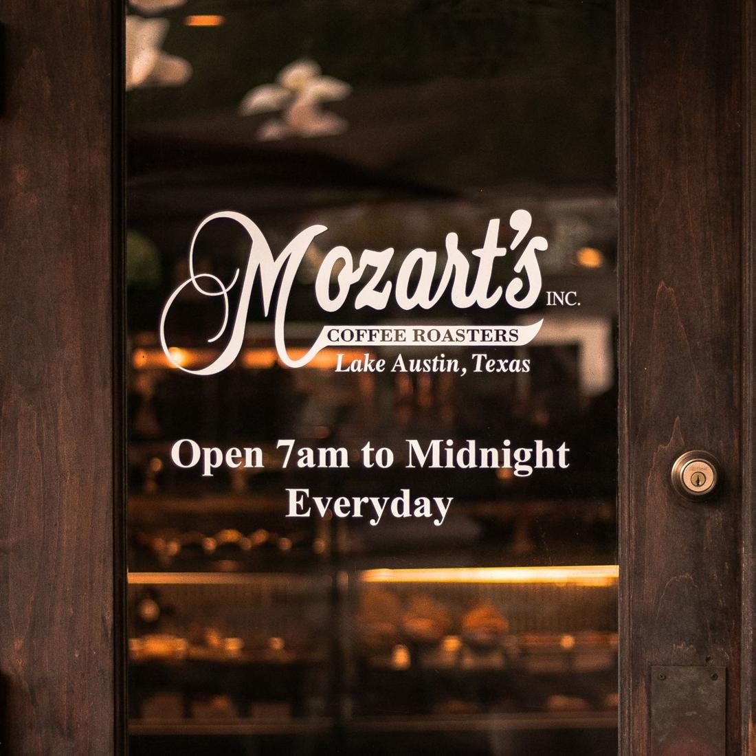 The Mozart's front door, signed Open 7 AM to Midnight Everyday
